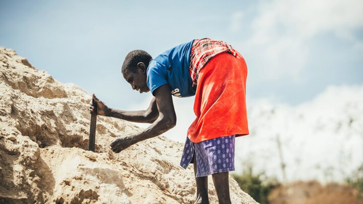 A quarry scavenger woman searching for rocks