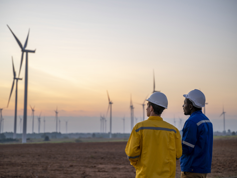 Two workers at a wind farm