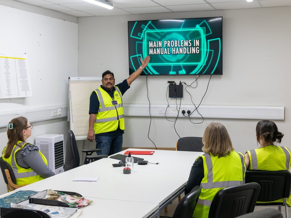 Workplace safety training session on manual handling.