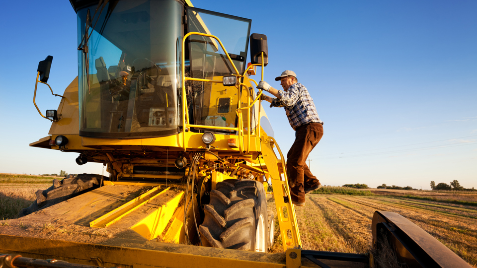 Farmer entering combine harvester