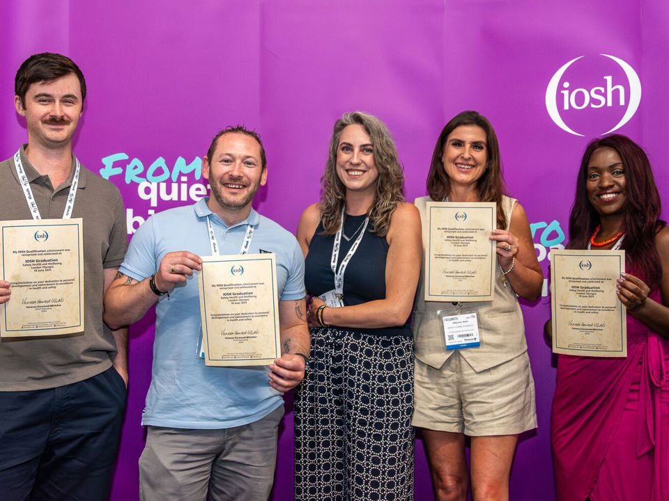 IOSH President Kelly Nicoll with four students holding their IOSH qualification certificates
