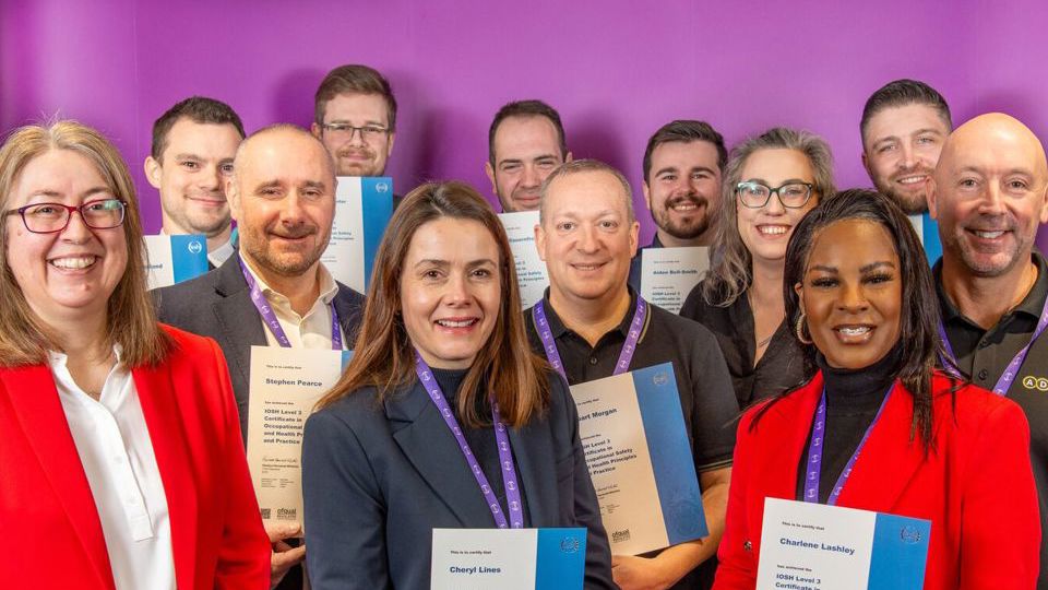 A crowd of people holding their IOSH certificates