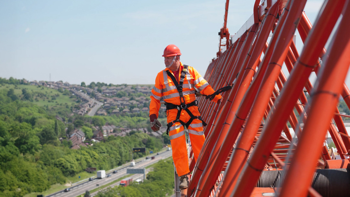 Man working at height on a bridge