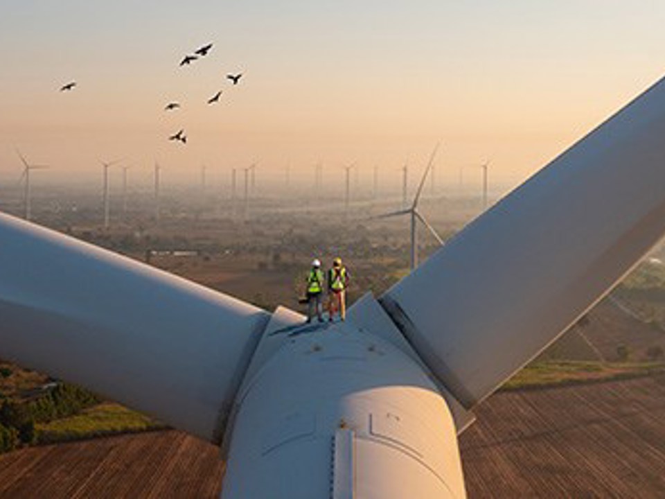 Technicians working on wind turbine blades