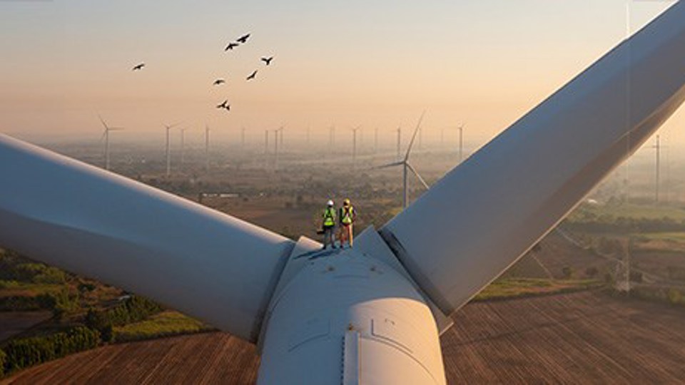 Technicians working on wind turbine blades