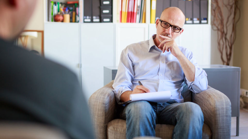 Man talks to another in office