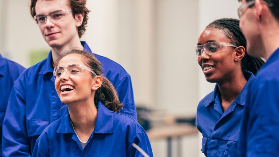 Four young lab workers laughing together