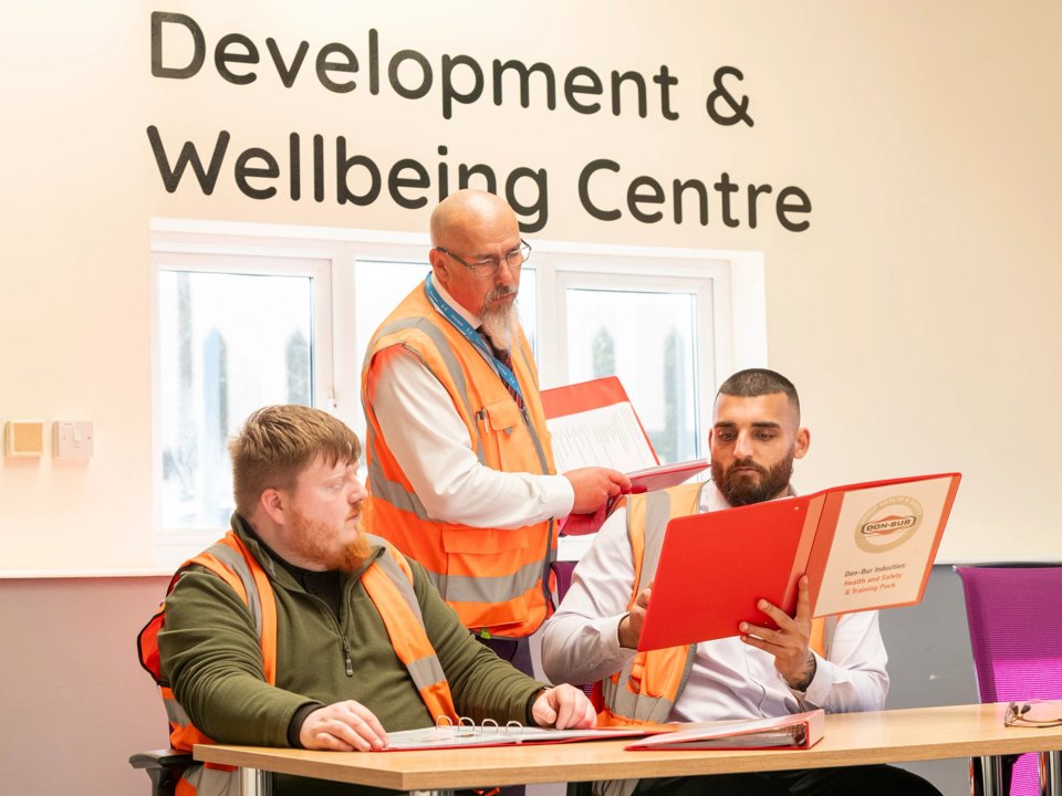 Trainer leading a class for two seated professionals