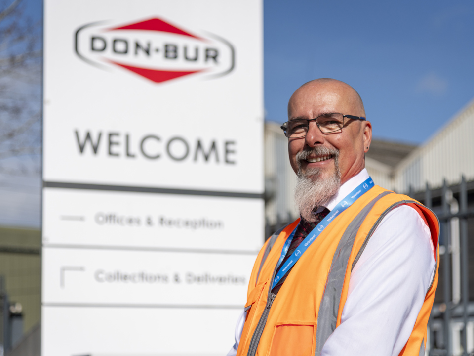 Mark Nixon standing in front of the Don-Bur welcome sign