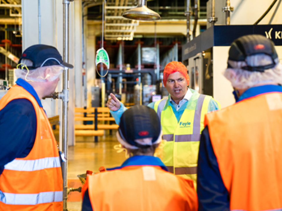 Man in high viz clothing presenting to colleagues