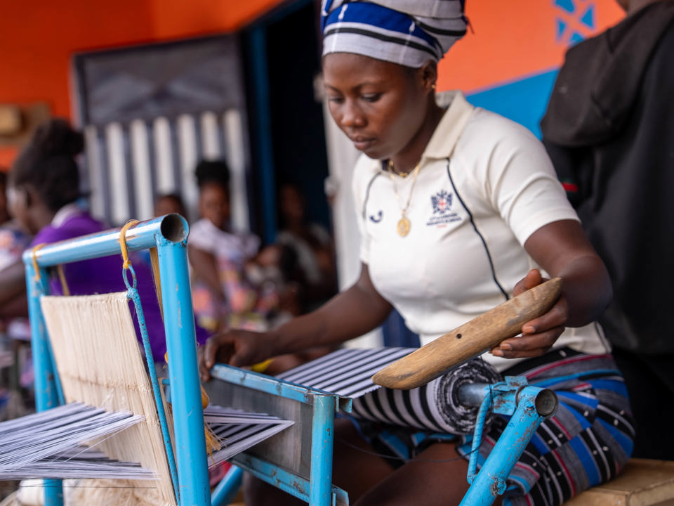 Textile worker working on loom