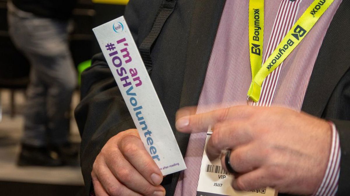 Volunteer showing his bookmark give-away