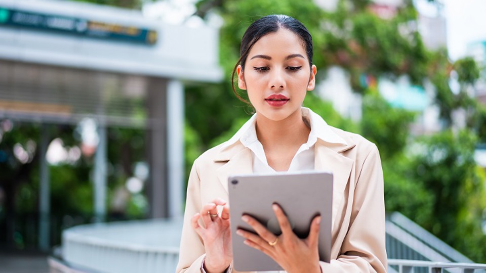 Woman outdoors using a tablet