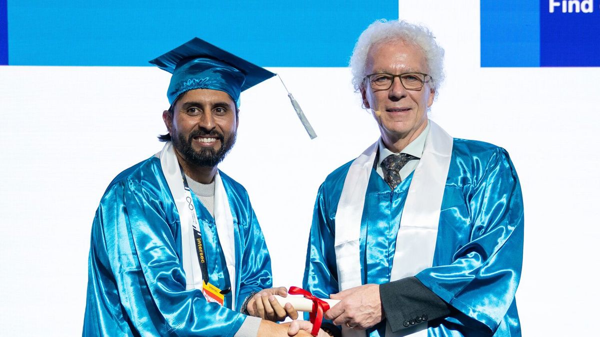 IOSH graduate receiving certificate from IOSH President Richard Bate at graduation ceremony during Intersec Dubai 2026 event.